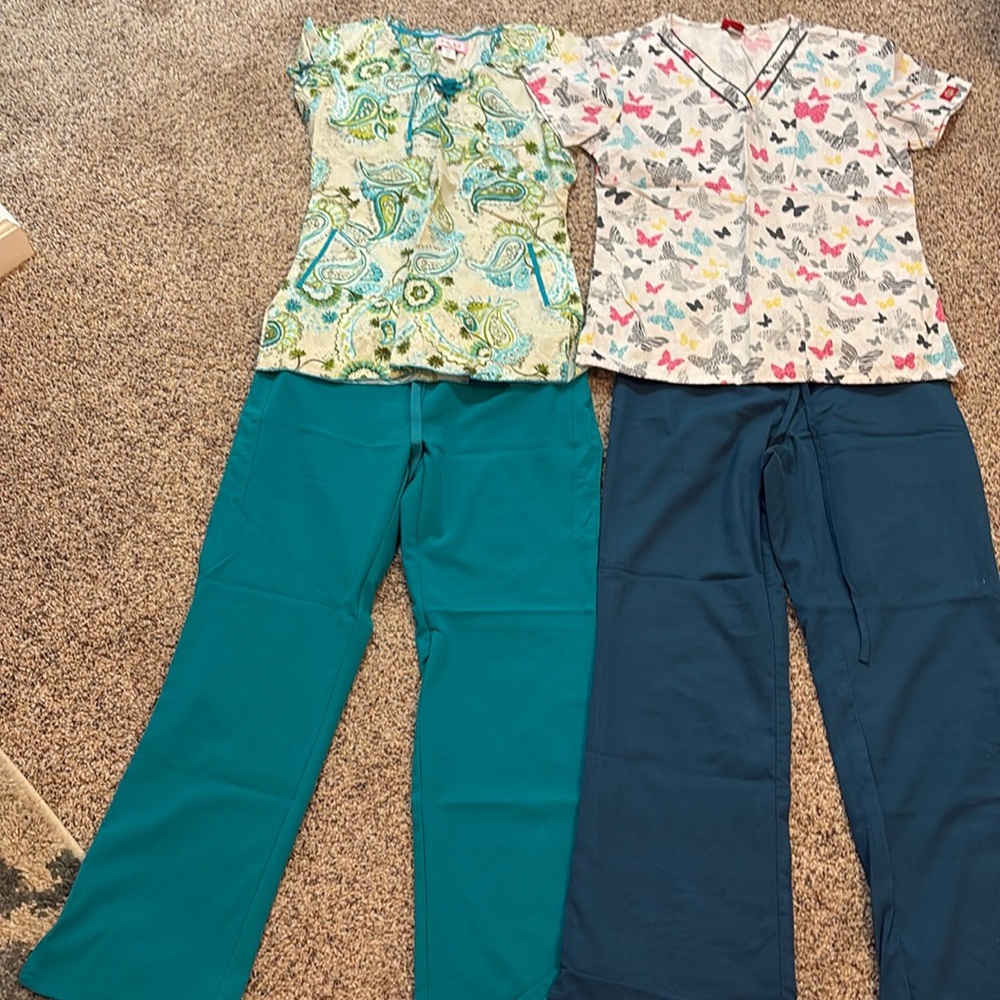 Mixed bundle of scrubs, range in size from extra small to small.